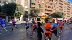 runners of the valencia marathon passing by our hotel